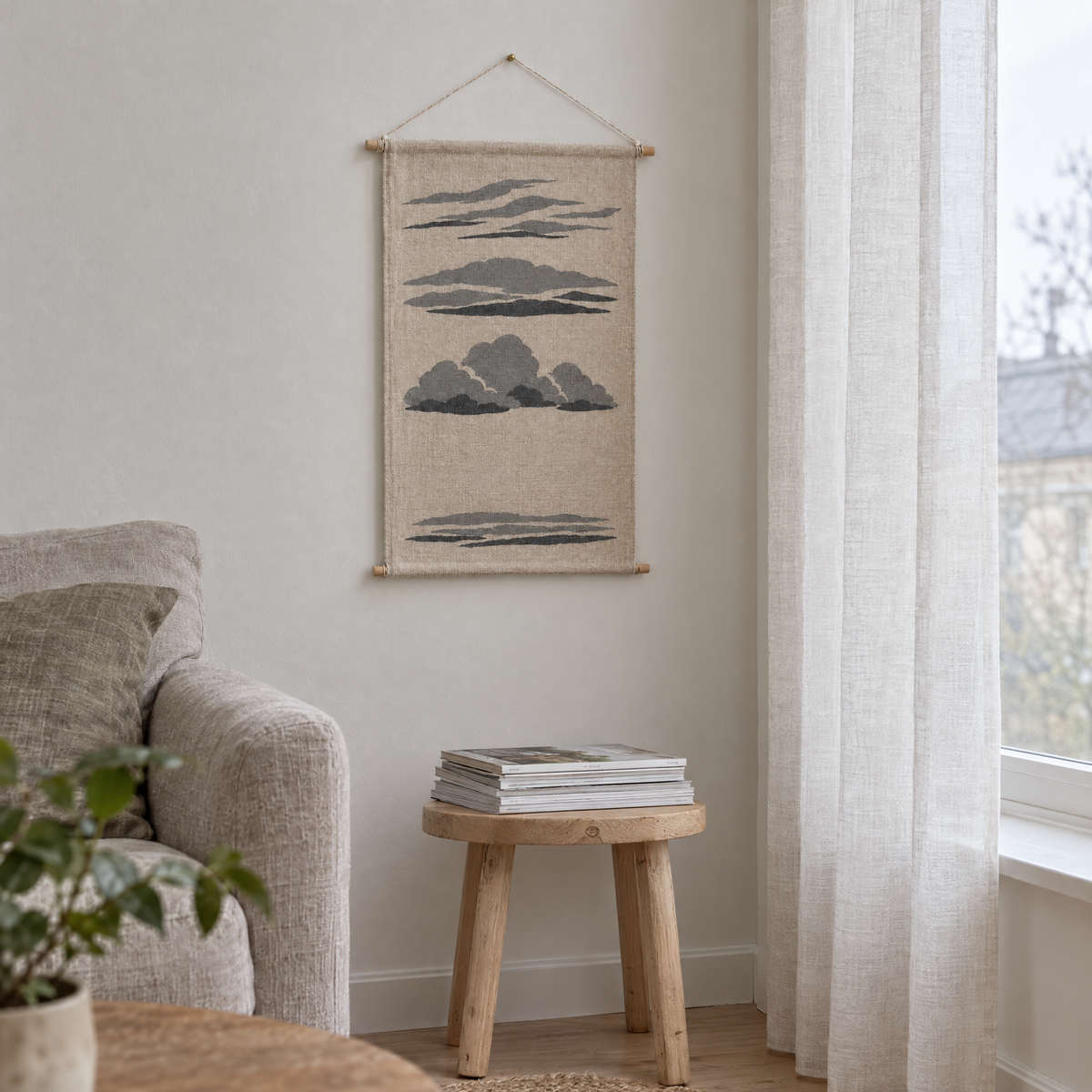 Cloud Types wall hanging beside a tall window with a linen curtain