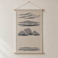 Cloud Types screen-printed canvas wall hanging on beech dowels, hung on a plain wall
