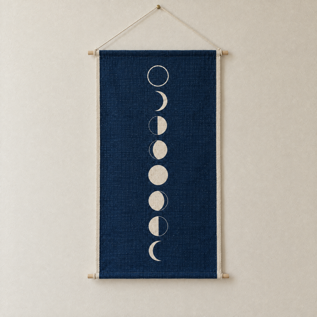 Moon Phases screen-printed canvas wall hanging on beech dowels, hung on a plain wall