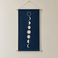 Moon Phases screen-printed canvas wall hanging on beech dowels, hung on a plain wall
