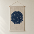 Star Chart screen-printed canvas wall hanging on beech dowels, hung on a plain wall