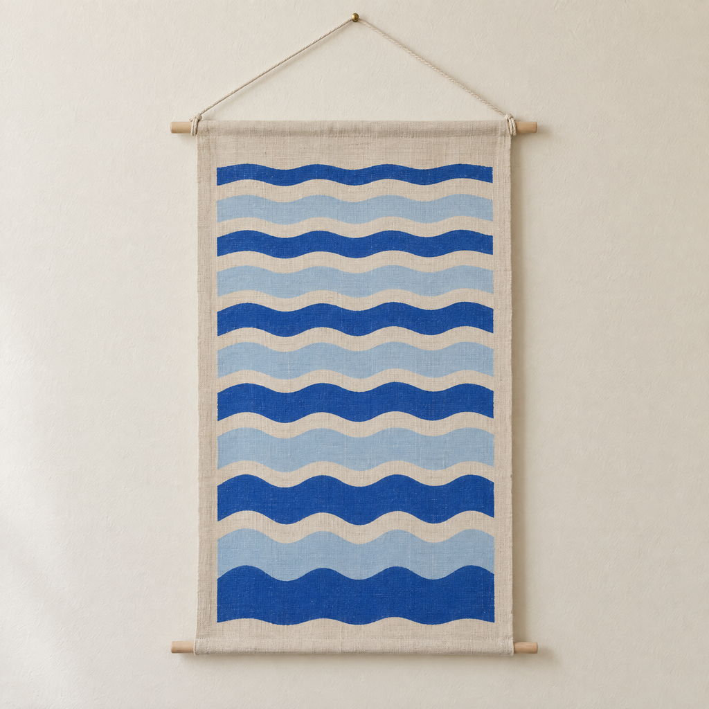 Tide Lines screen-printed canvas wall hanging on beech dowels, hung on a plain wall