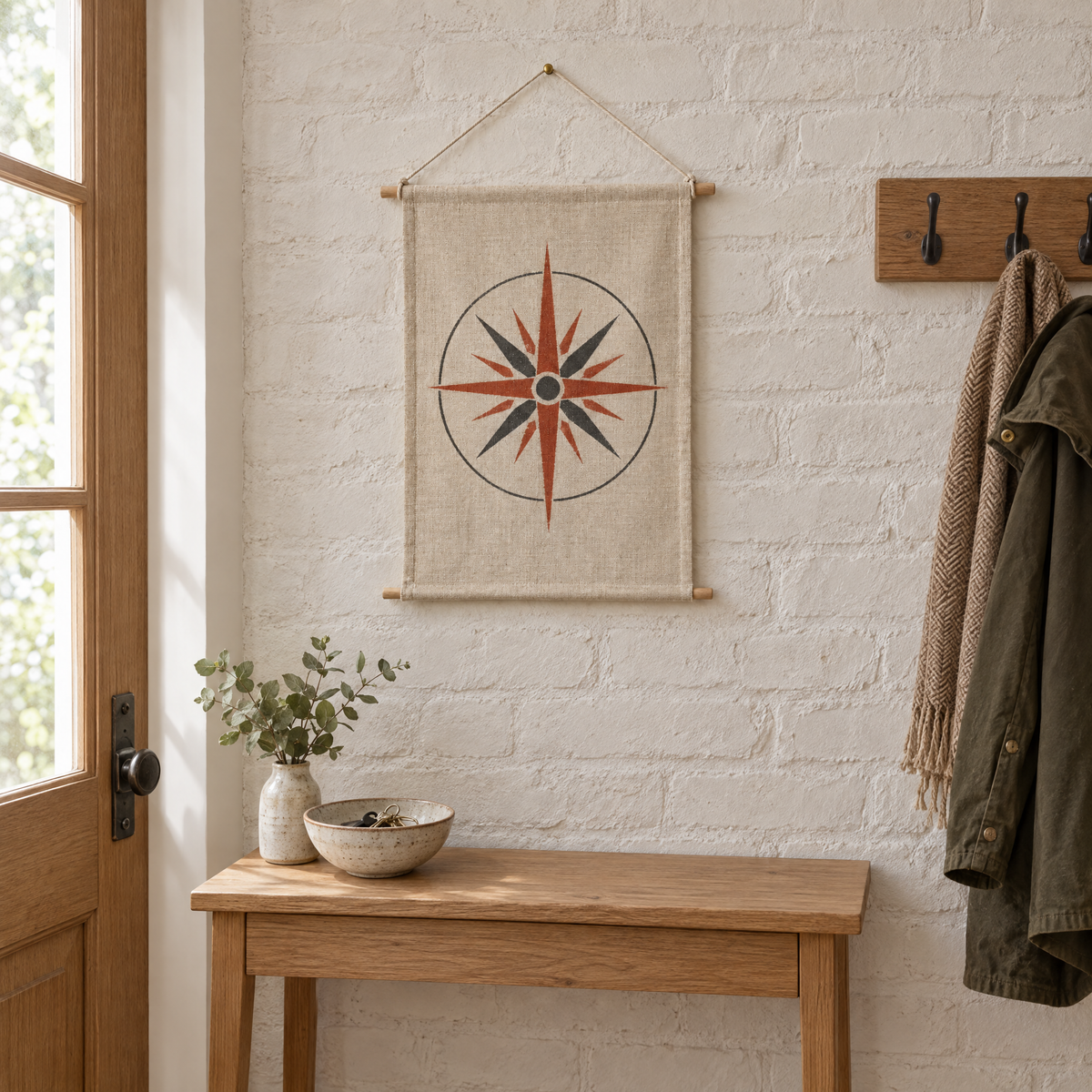 Wind Rose wall hanging on a whitewashed brick wall above a console table